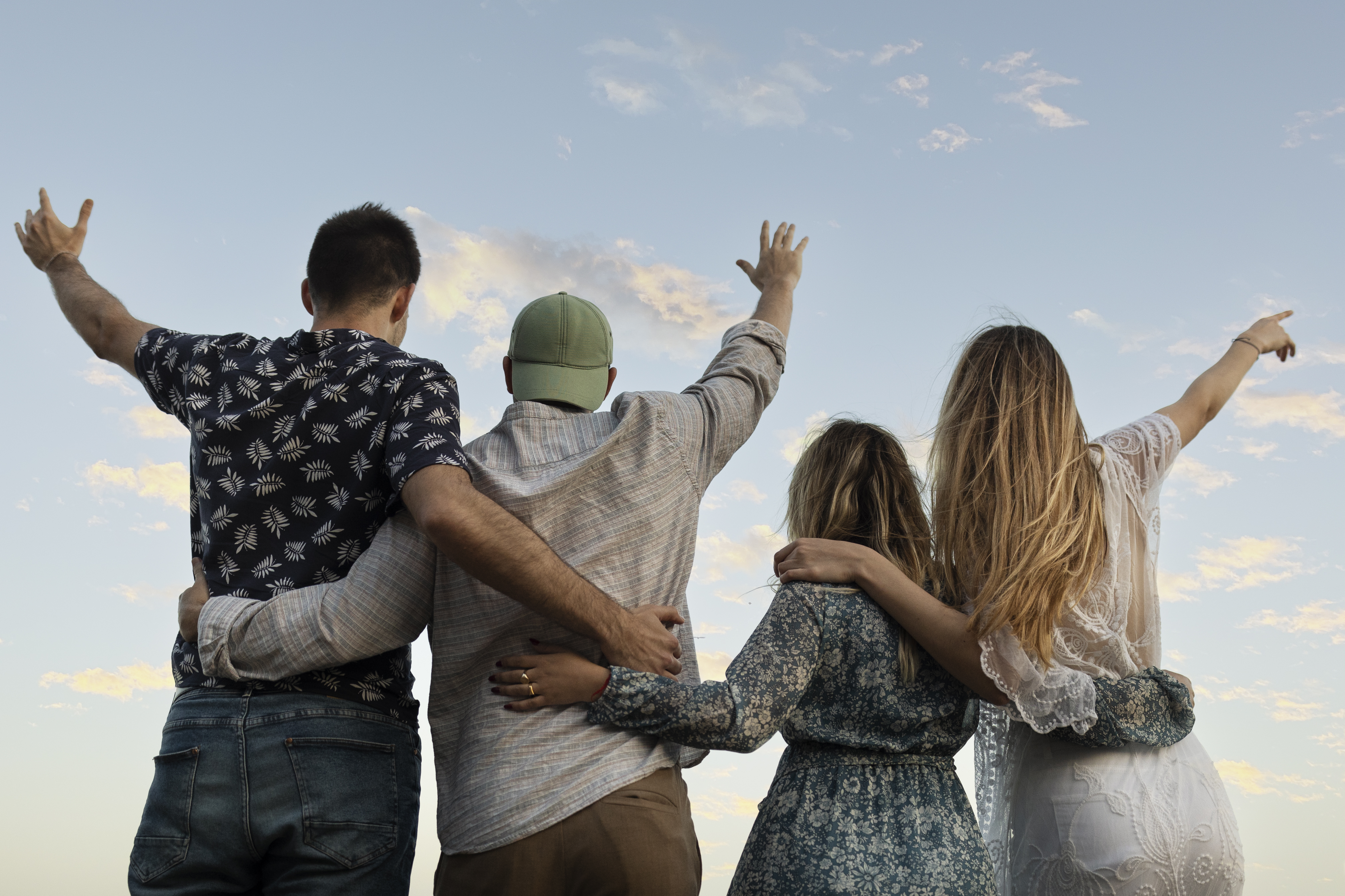 Friends Embracing Beach Looking Sky